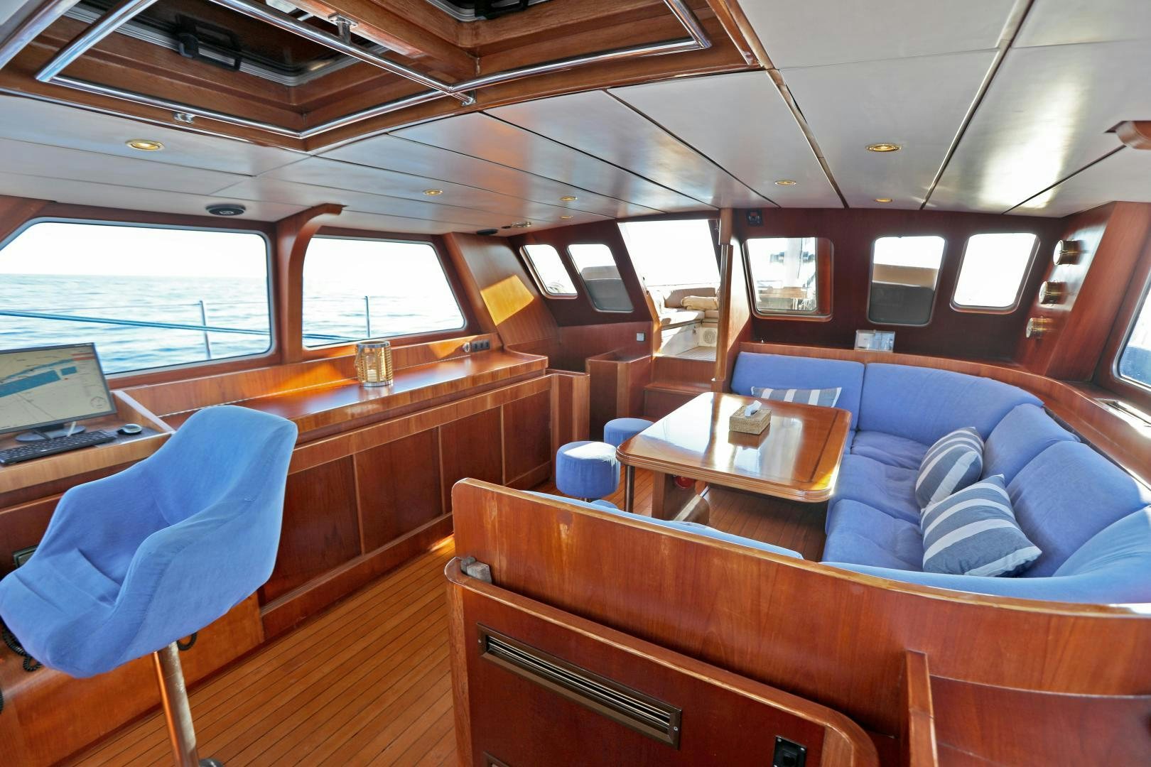a boat with a table and chairs aboard IRON MONKEY Yacht for Sale
