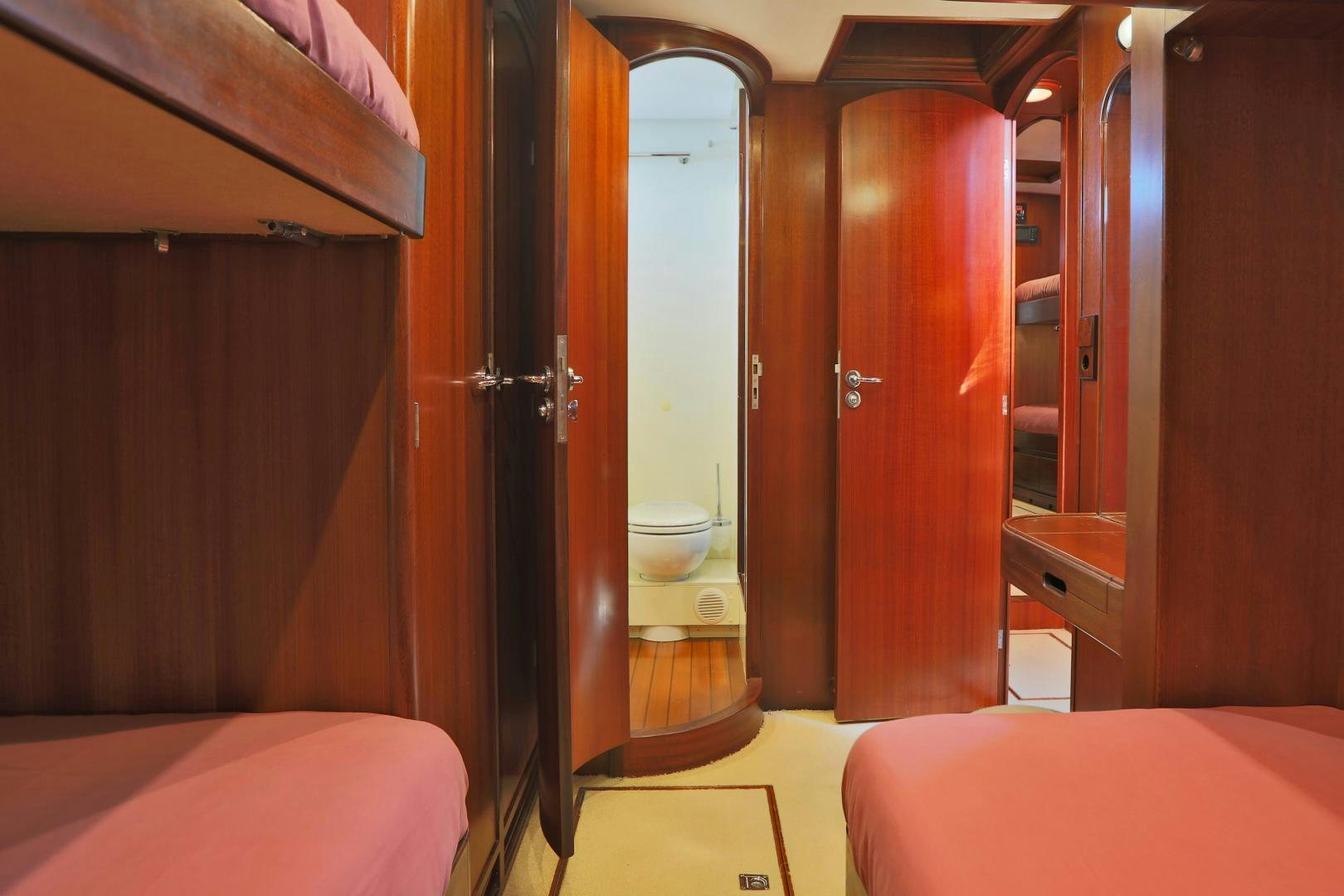 a room with a bed and a door aboard IRON MONKEY Yacht for Sale