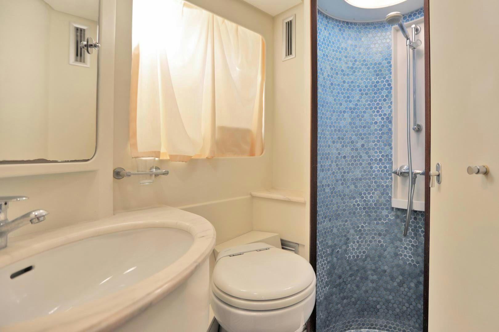 a bathroom with a tub sink and toilet aboard IRON MONKEY Yacht for Sale