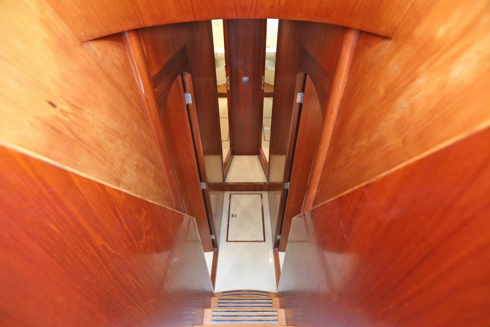 a wooden staircase with a wood railing aboard IRON MONKEY Yacht for Sale