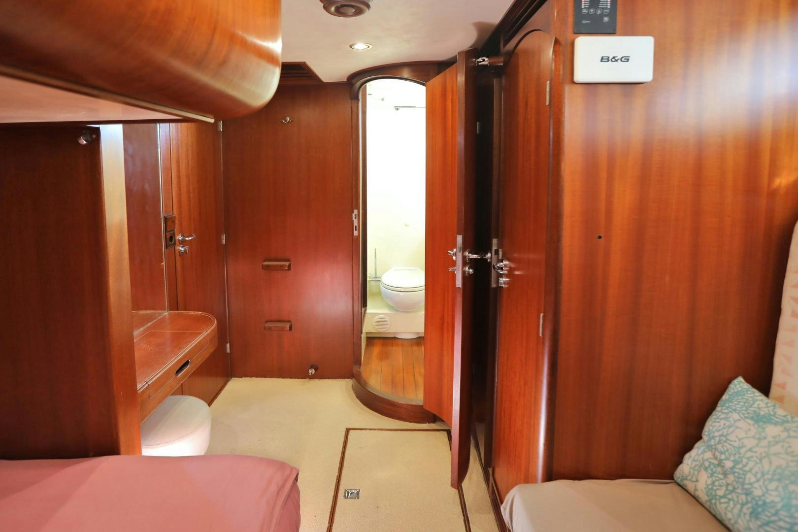 a bathroom with a bed and a mirror aboard IRON MONKEY Yacht for Sale