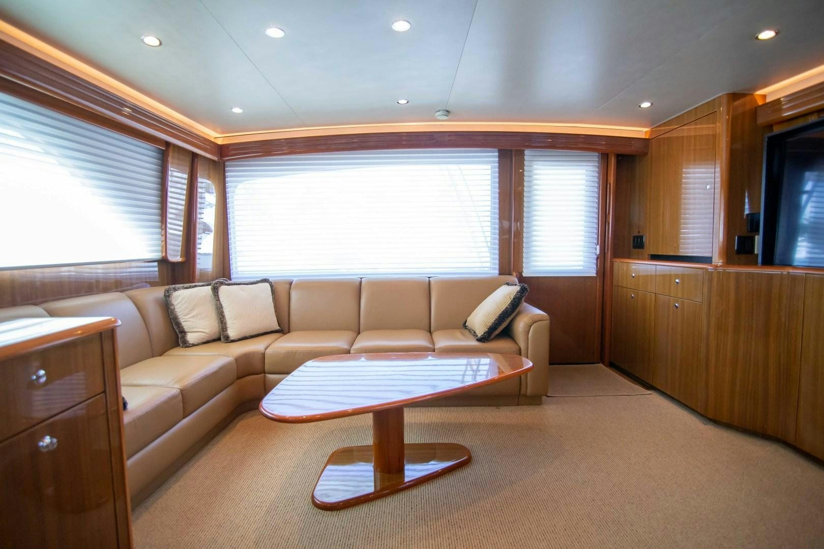 a living room with a couch and a table aboard LUNA Yacht for Sale