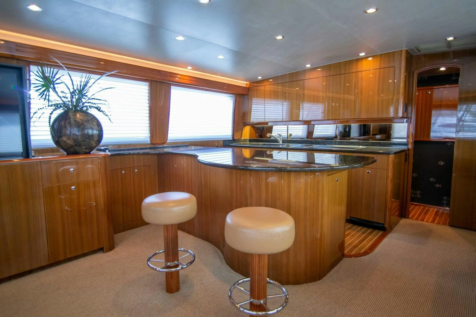 a kitchen with wooden cabinets aboard LUNA Yacht for Sale