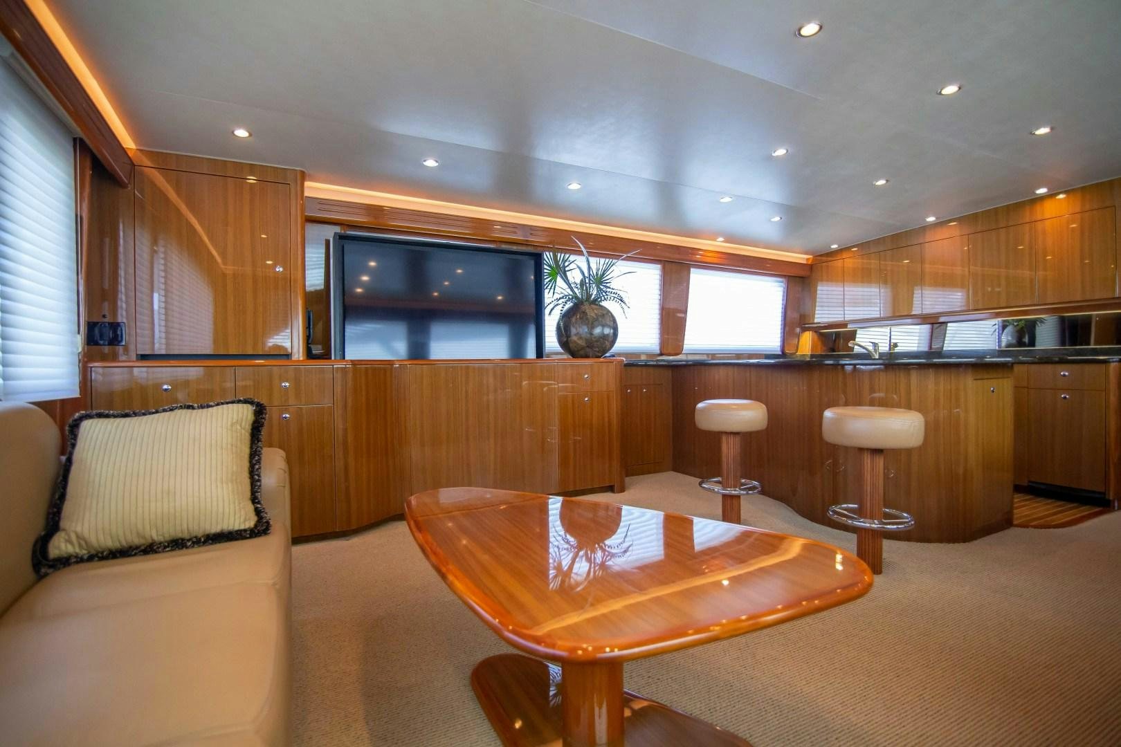 a large living room with a table aboard LUNA Yacht for Sale