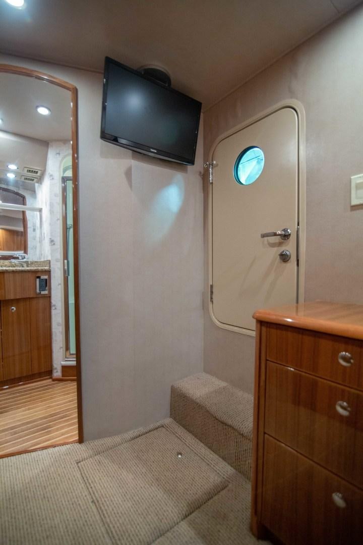 a bathroom with a tv on the wall aboard LUNA Yacht for Sale