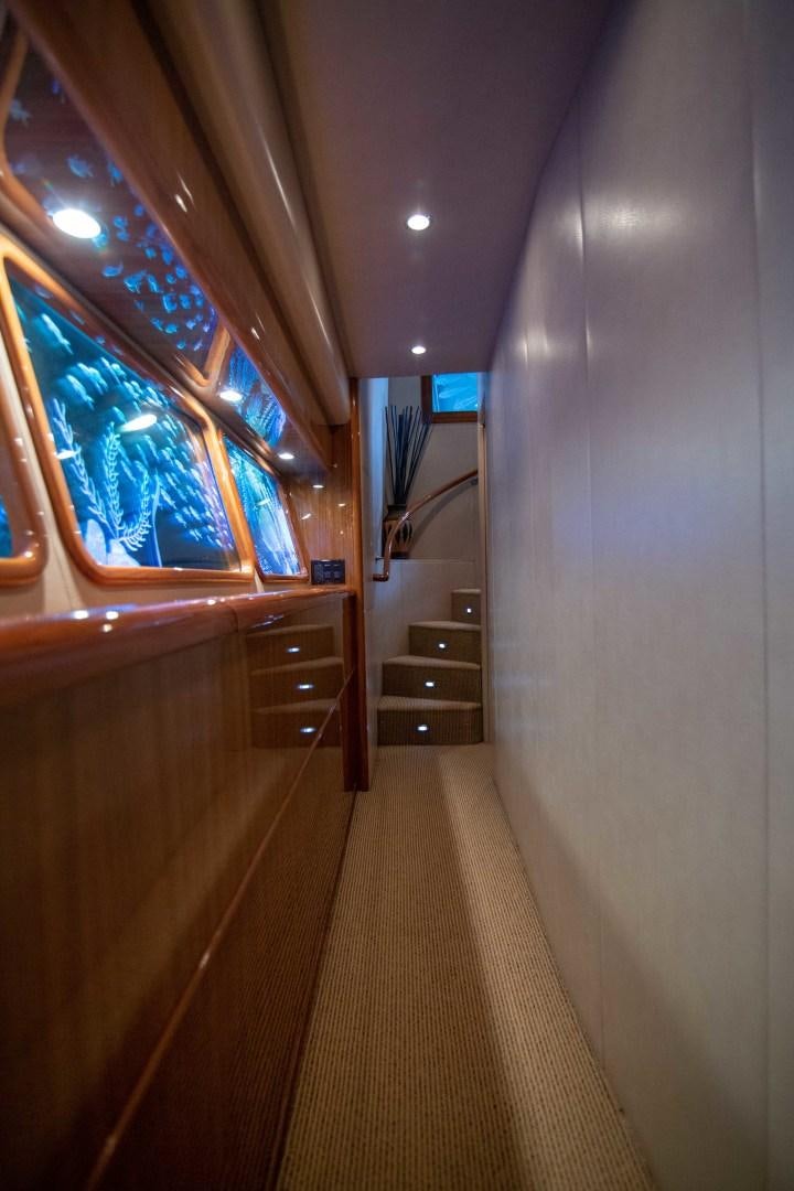 a hallway with a wood door and a window with a wood railing aboard LUNA Yacht for Sale