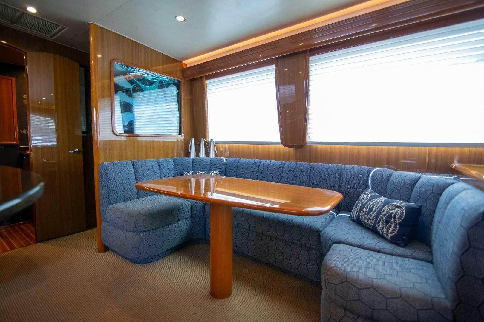 a living room with a table and chairs aboard LUNA Yacht for Sale