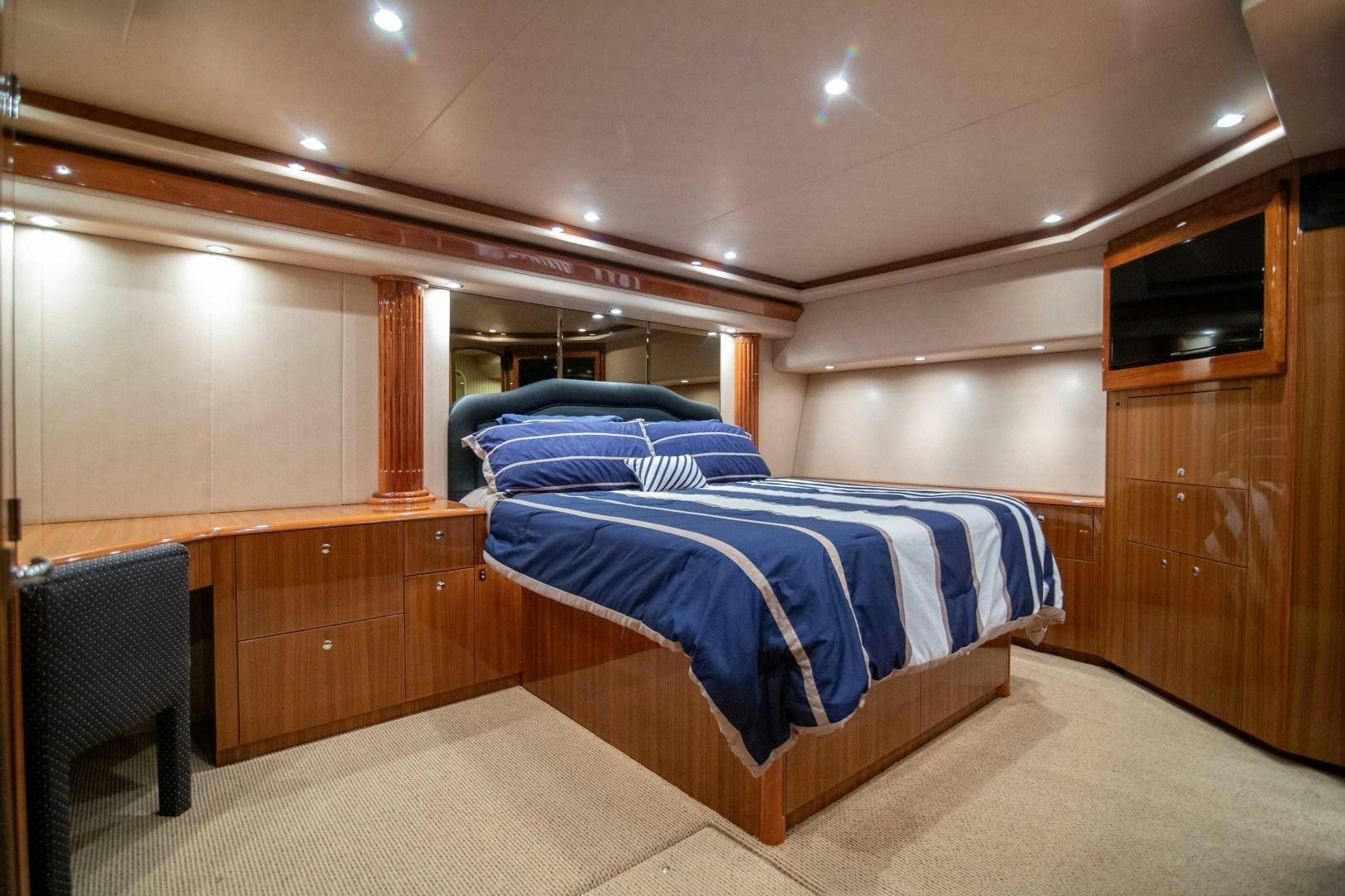 a room with a bed and a desk aboard LUNA Yacht for Sale