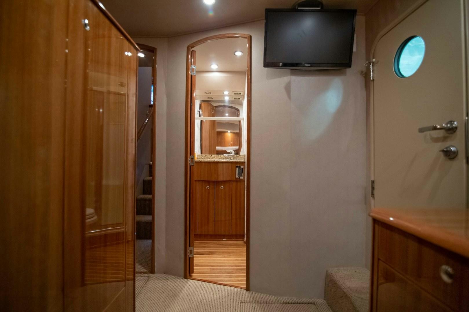 a bathroom with a tv on the wall aboard LUNA Yacht for Sale