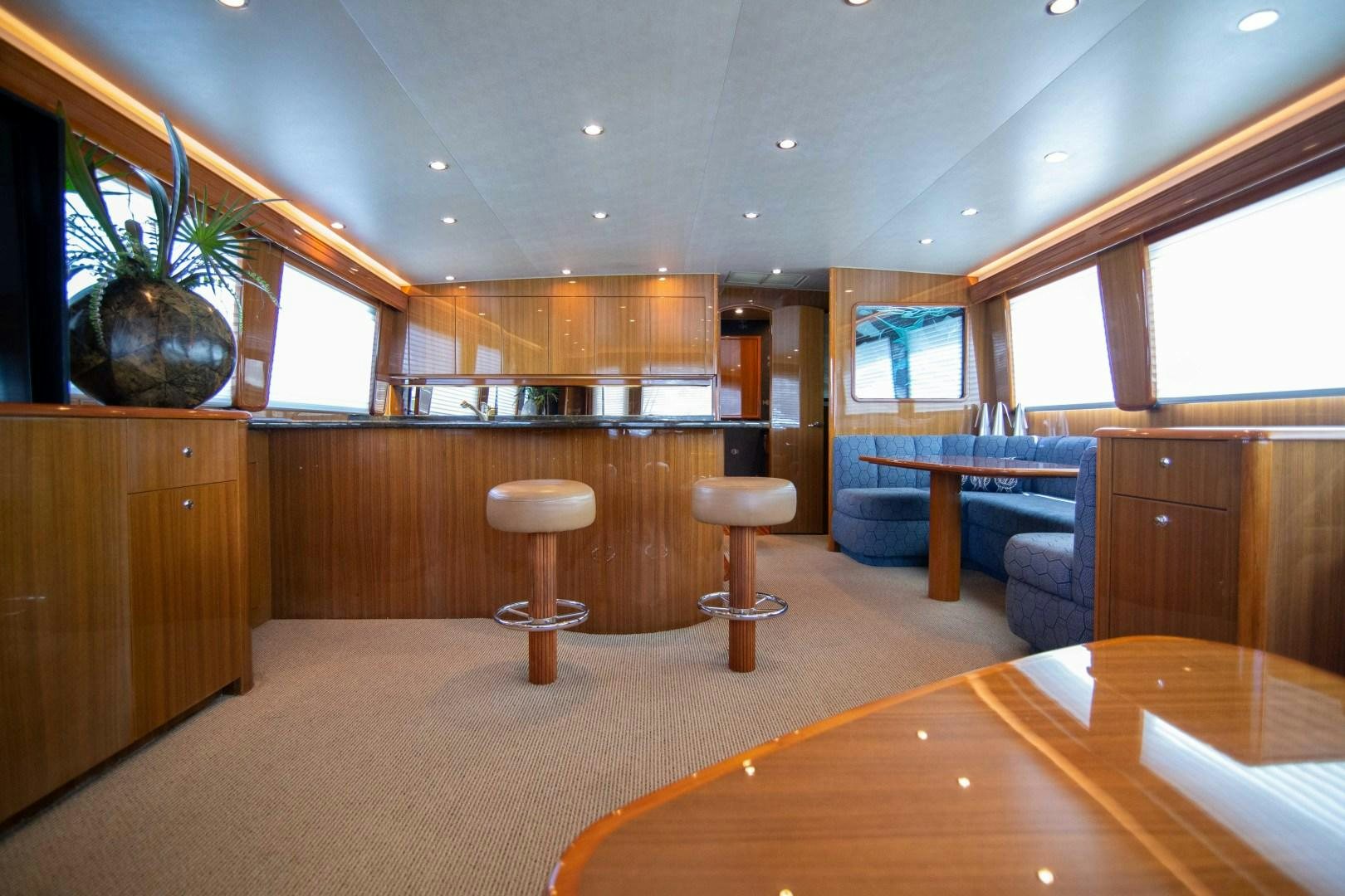 a room with a table and stools aboard LUNA Yacht for Sale