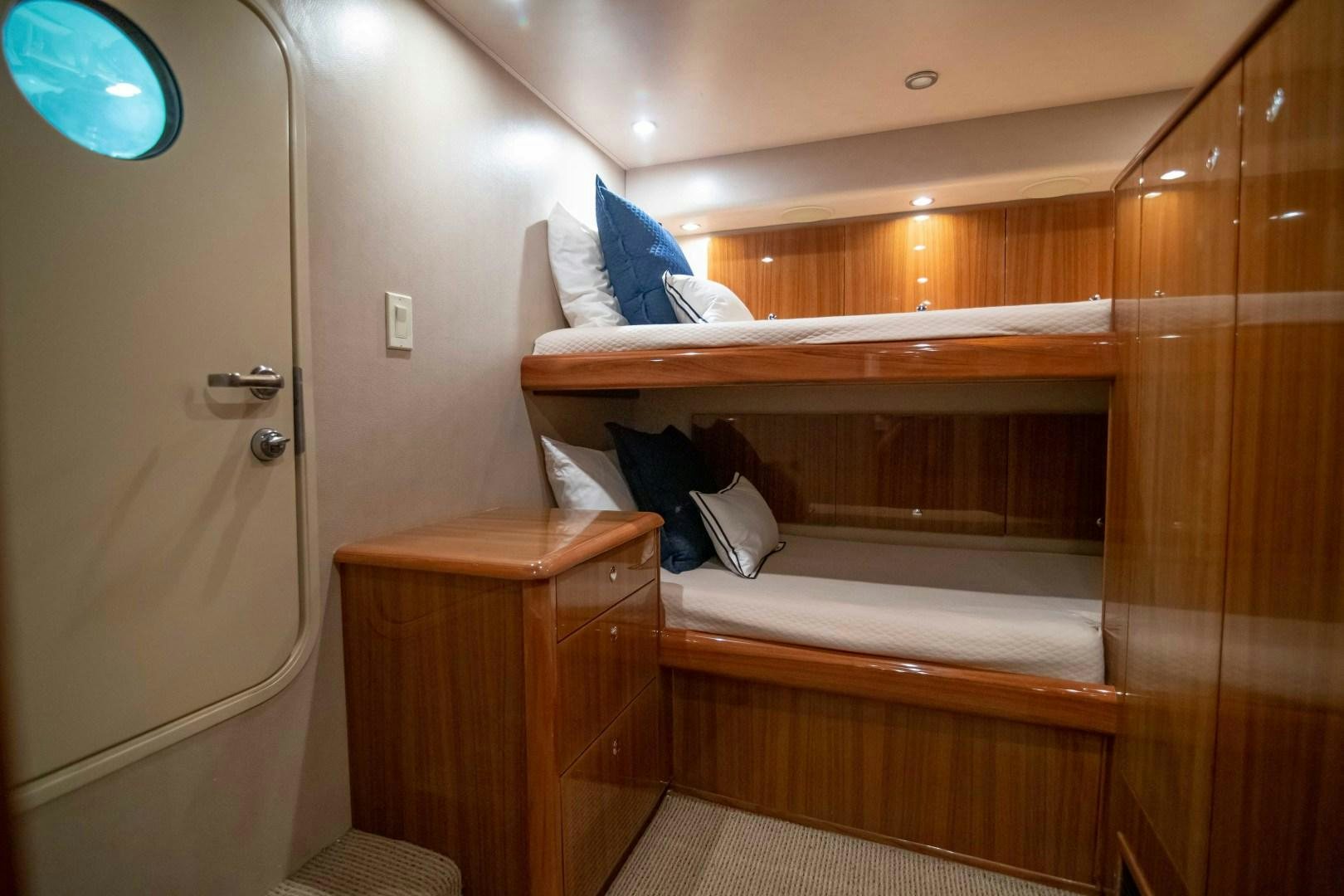 a room with a bed and a closet aboard LUNA Yacht for Sale