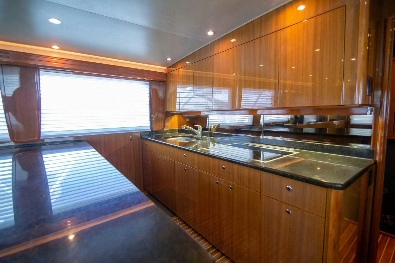 a kitchen with wooden cabinets aboard LUNA Yacht for Sale