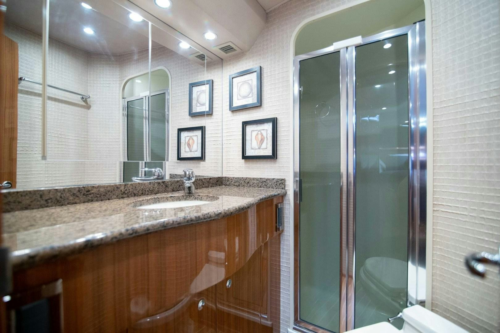 a bathroom with a marble counter top aboard LUNA Yacht for Sale
