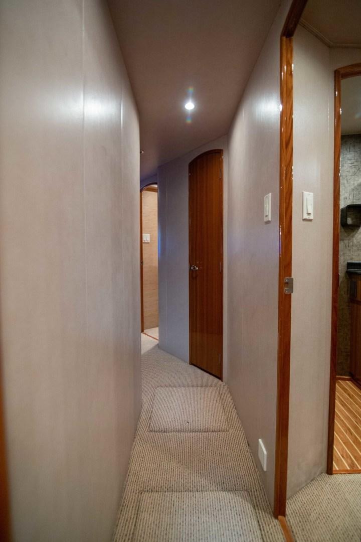 a hallway with a carpet and doors aboard LUNA Yacht for Sale