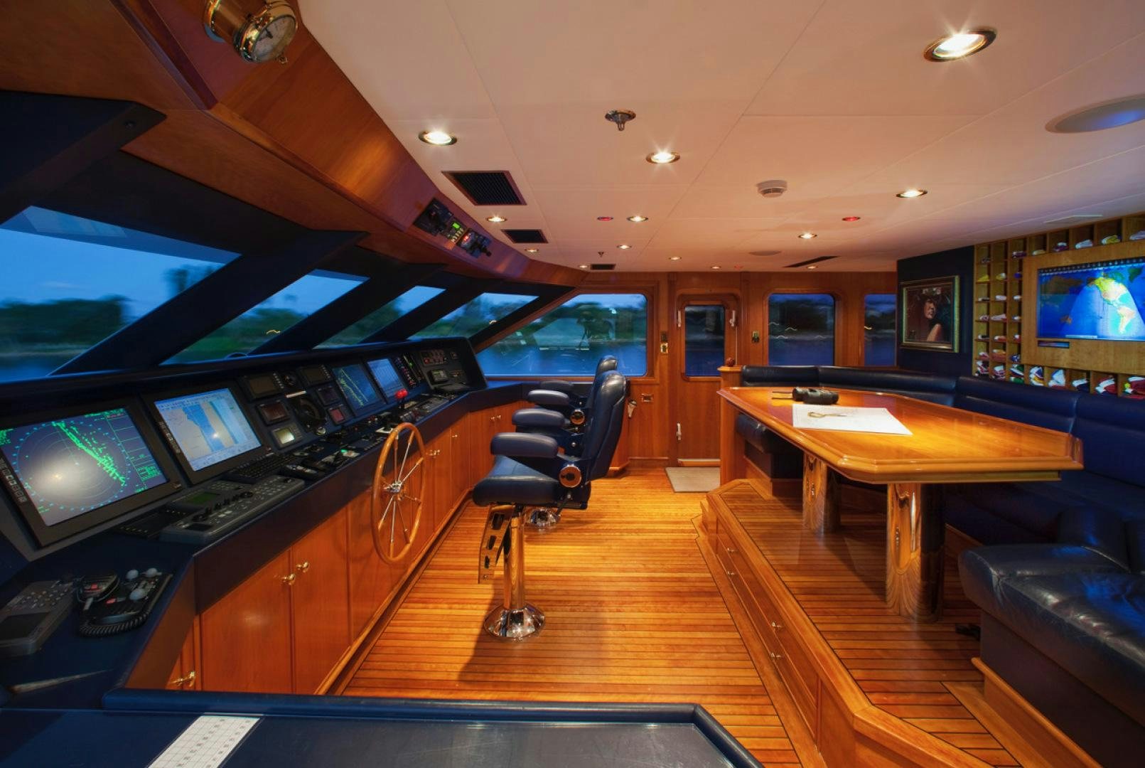 a room with a table and chairs aboard LEVERAGE Yacht for Sale