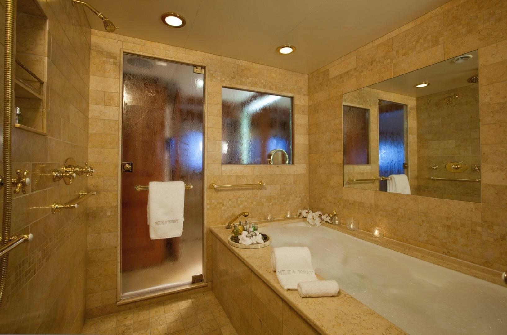 a bathroom with a bathtub and shower aboard LEVERAGE Yacht for Charter