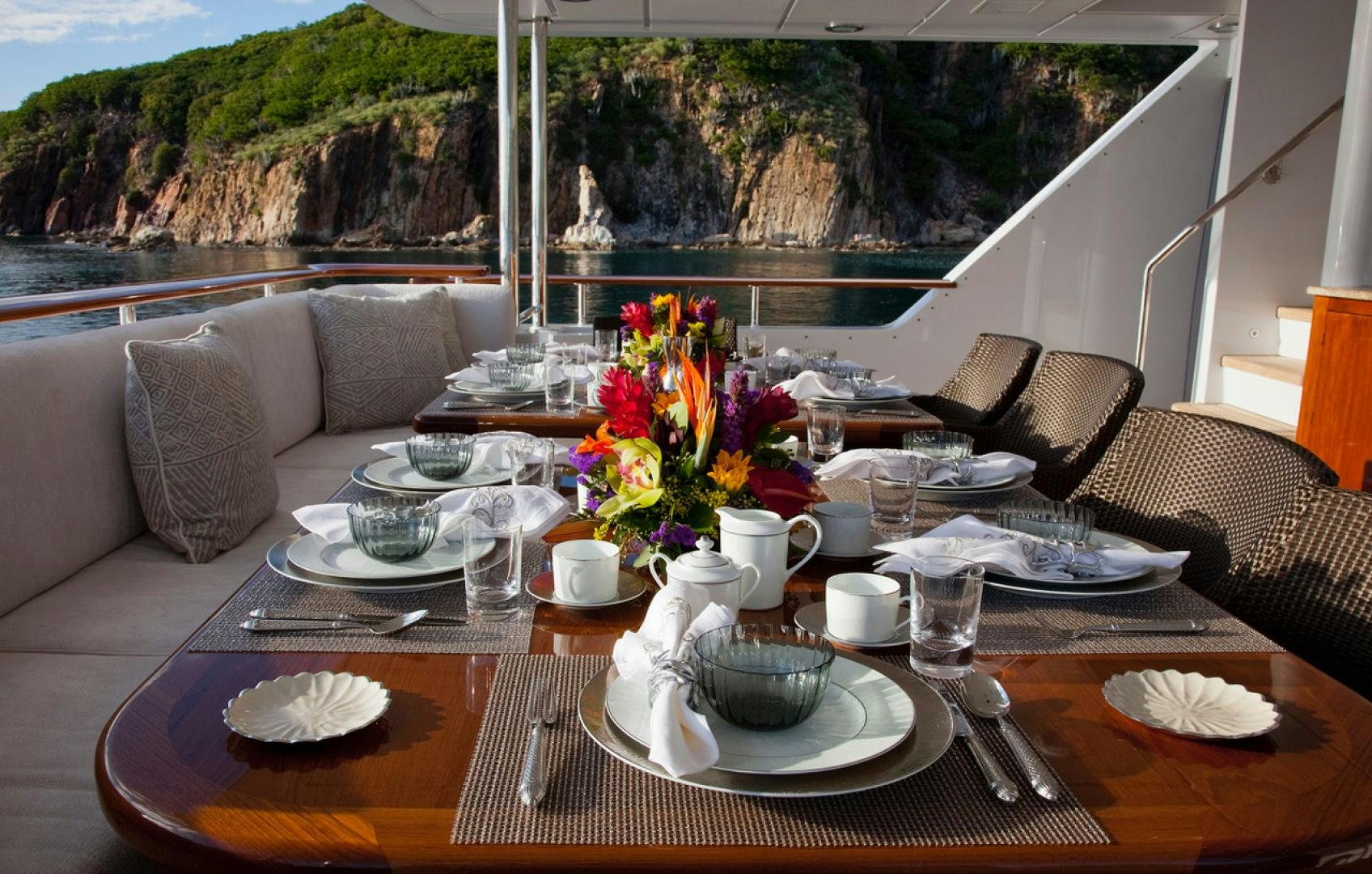 a table with plates and cups on it aboard LEVERAGE Yacht for Charter