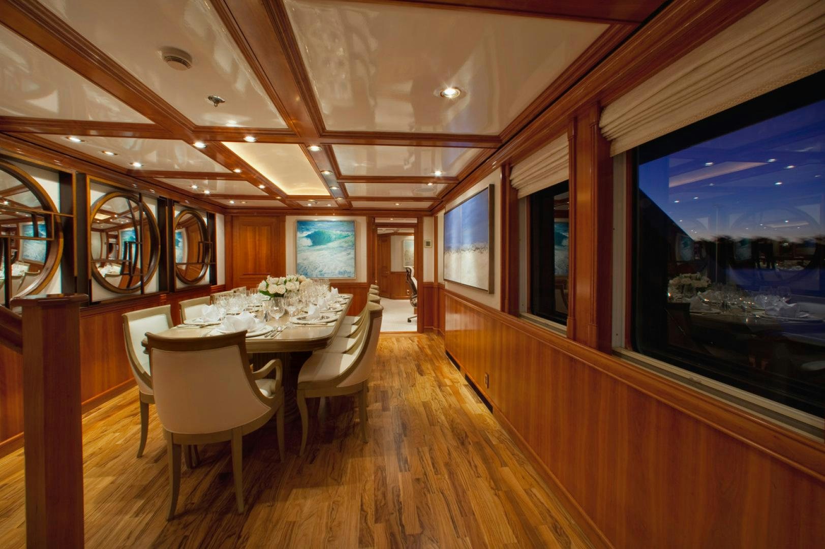 a room with tables and chairs aboard LEVERAGE Yacht for Sale
