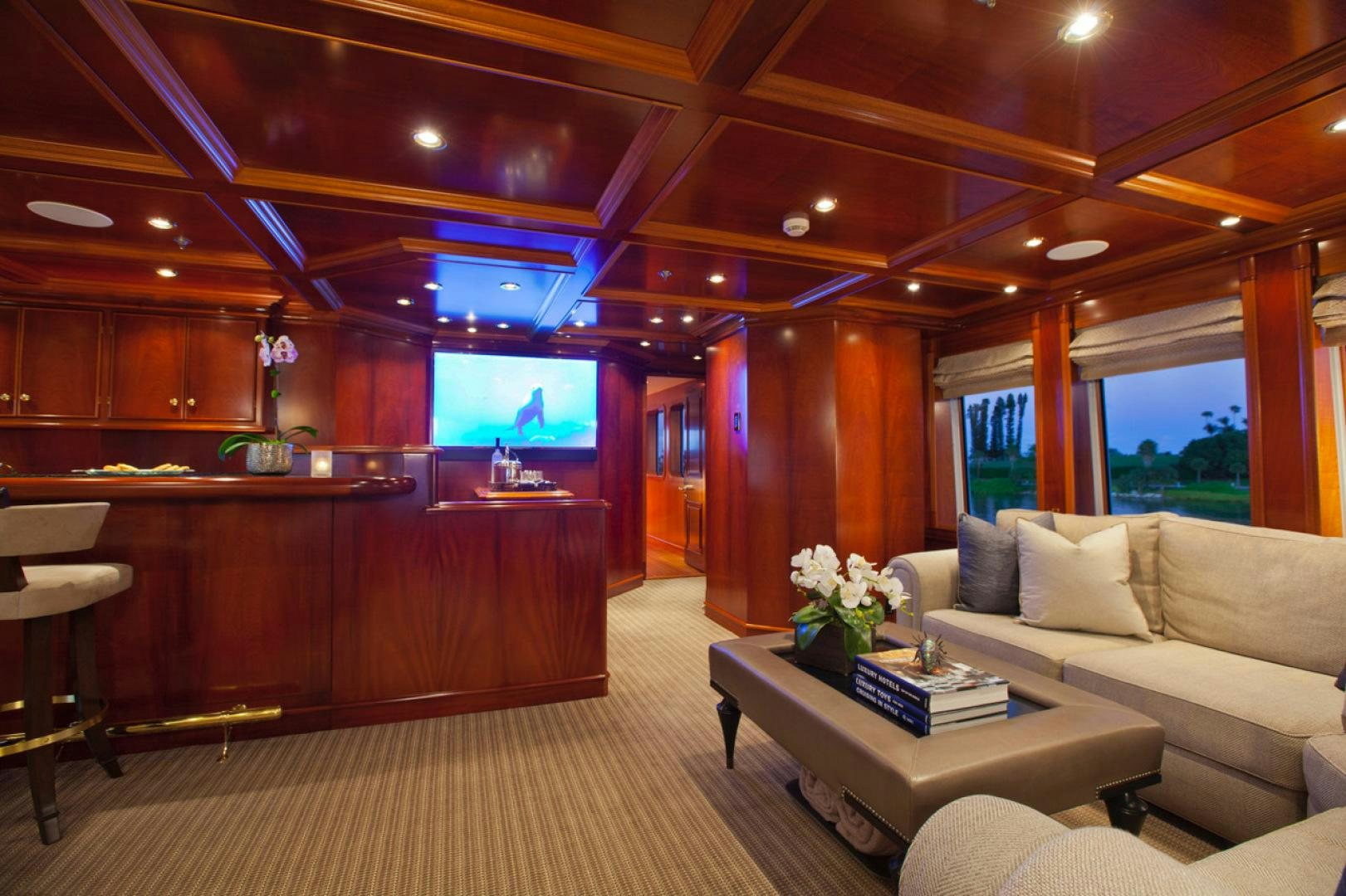 a room with a couch and a television aboard LEVERAGE Yacht for Charter
