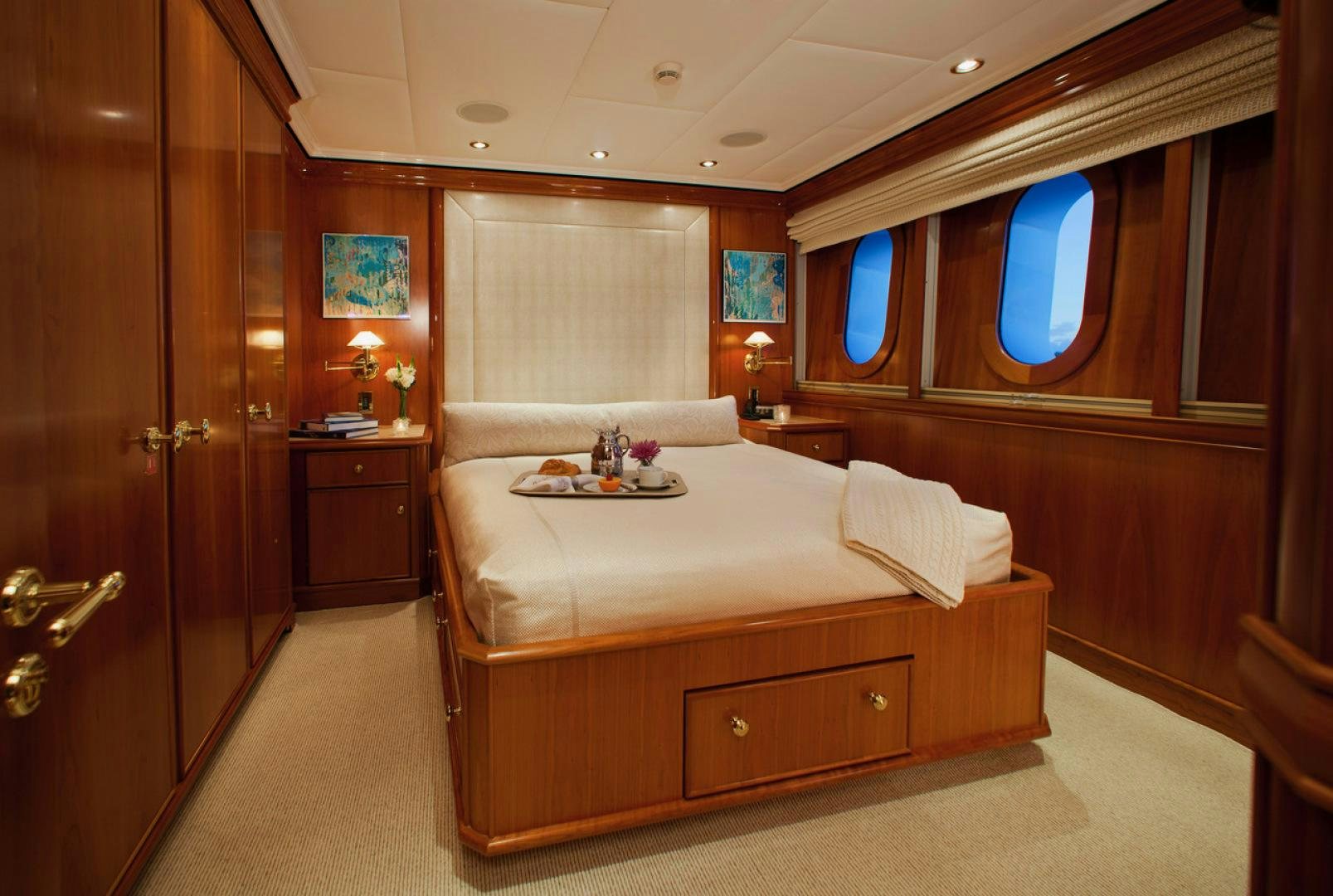 a bedroom with a bed and a desk aboard LEVERAGE Yacht for Sale