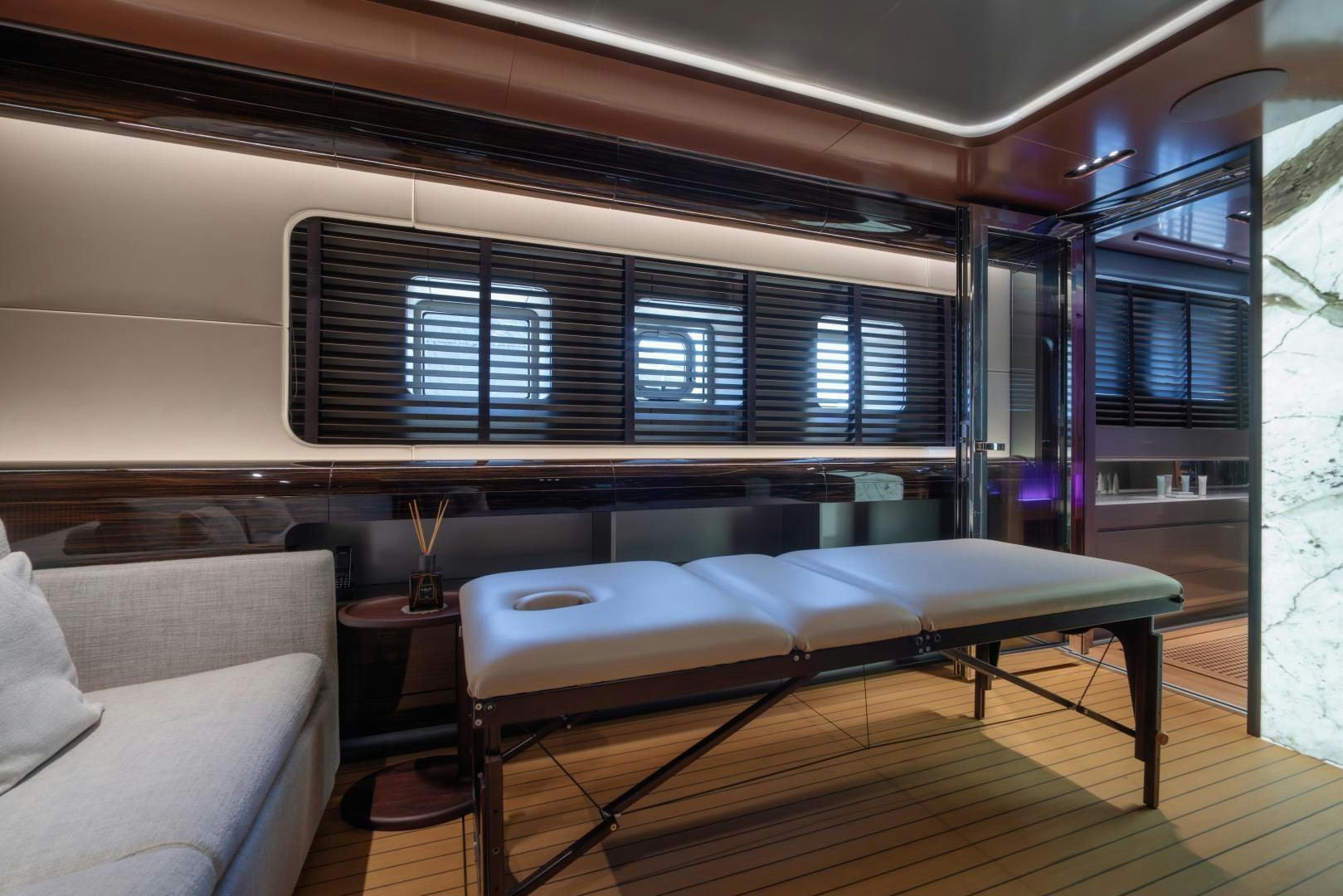 a living room with a couch and a window aboard LA VIE Yacht for Sale