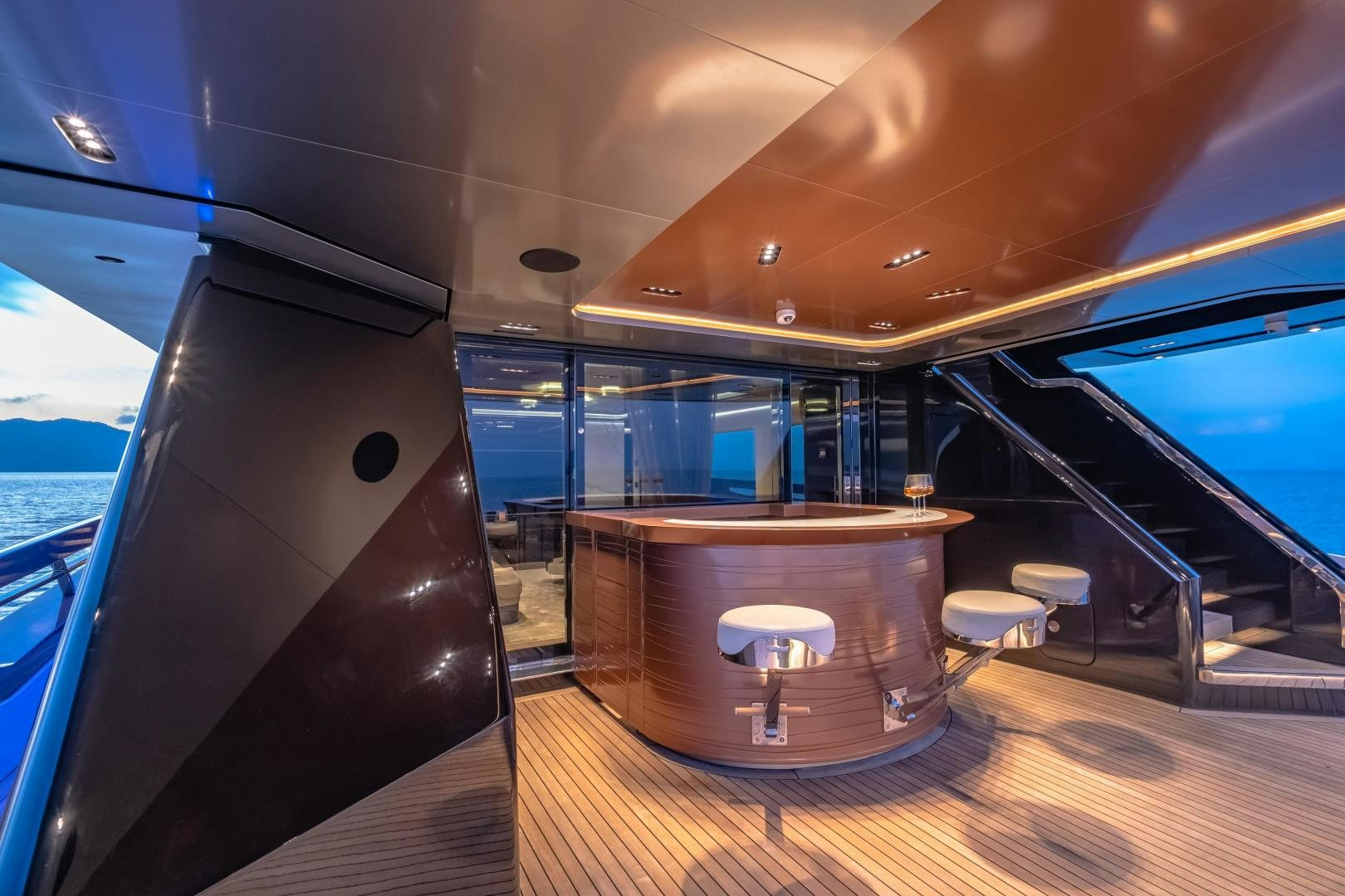 a room with a large window and a table with chairs and a view of the ocean aboard LA VIE Yacht for Sale