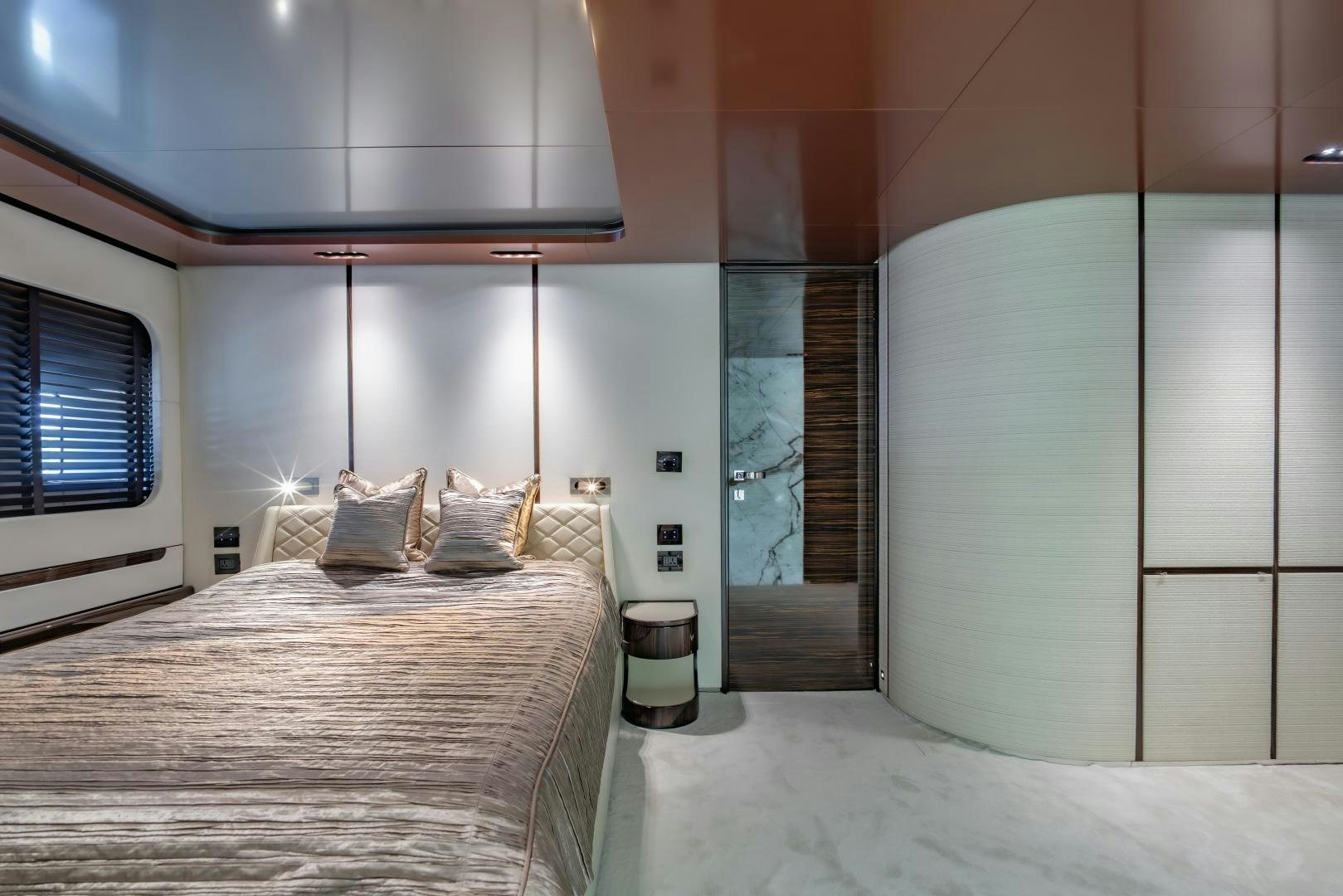 a bedroom with a bed and a window aboard LA VIE Yacht for Sale