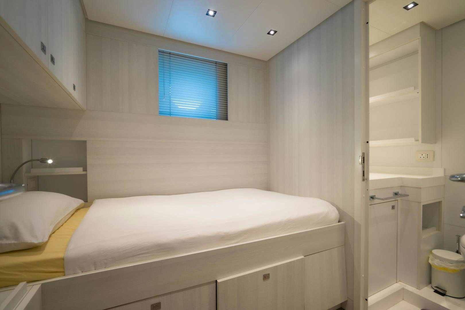 a room with a bed and a window aboard LA VIE Yacht for Sale
