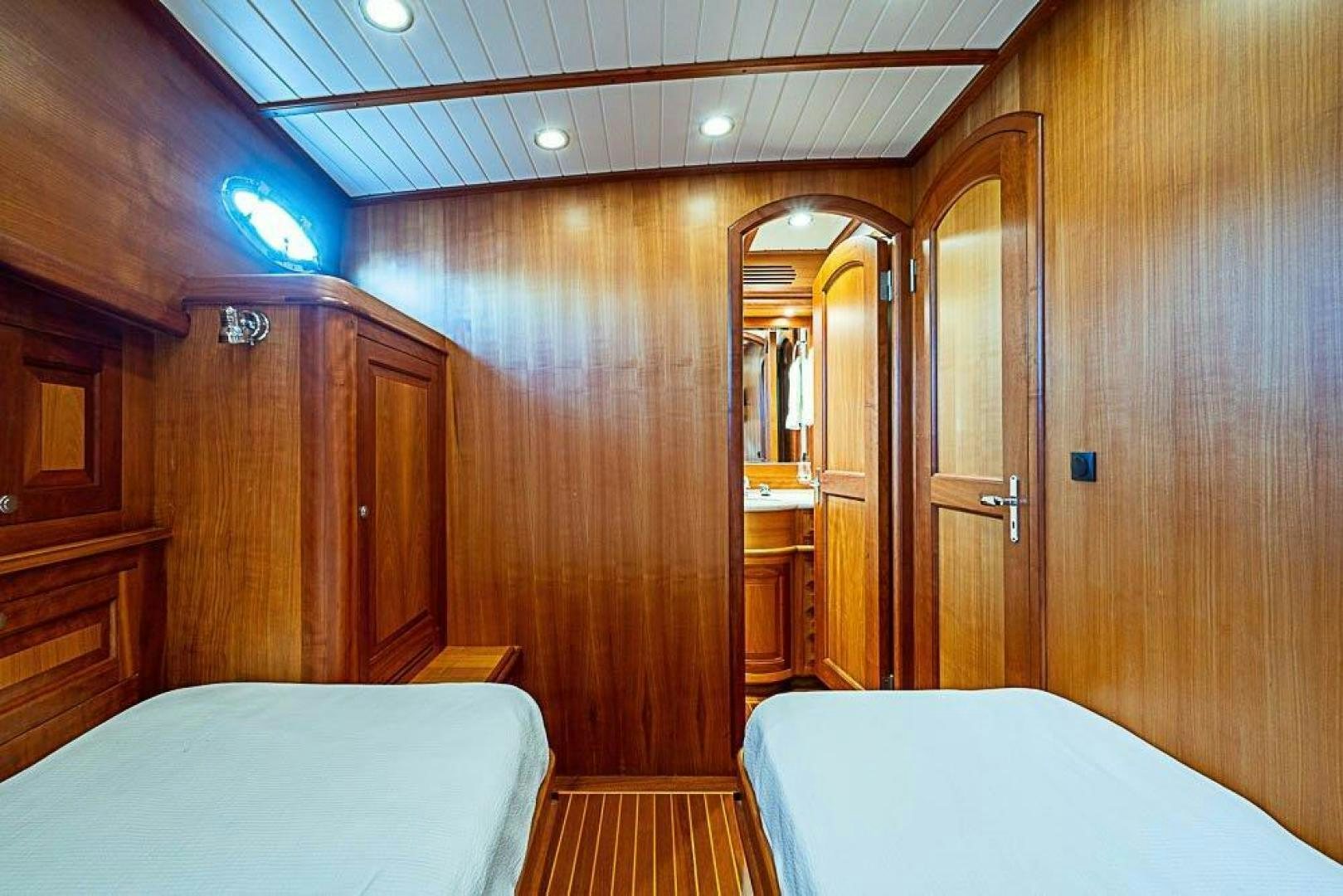 a room with a bed and a mirror aboard NAMHARA Yacht for Sale
