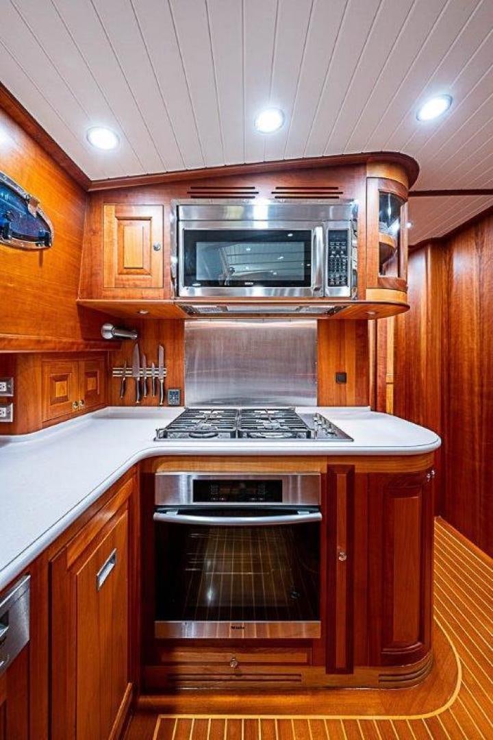 a kitchen with wooden cabinets aboard NAMHARA Yacht for Sale