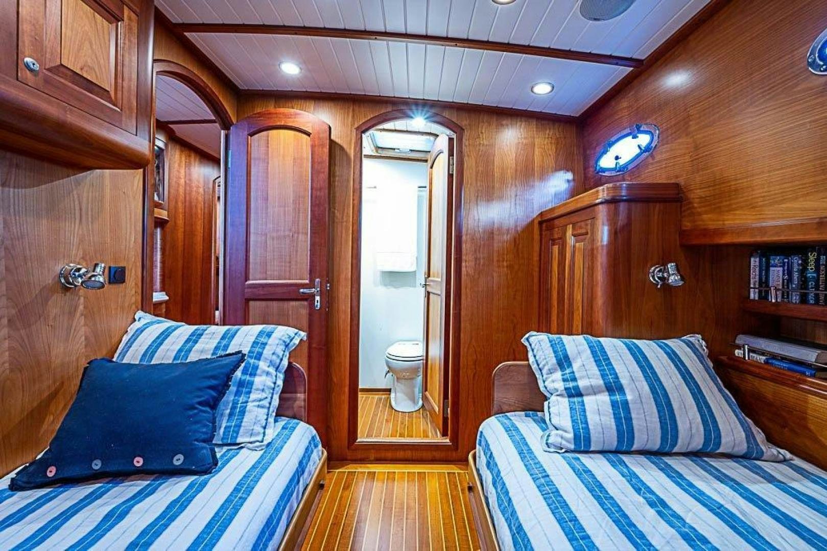 a room with a bed and a door aboard NAMHARA Yacht for Sale