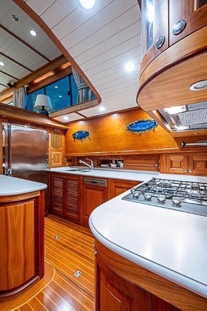 a kitchen with wooden cabinets aboard NAMHARA Yacht for Sale