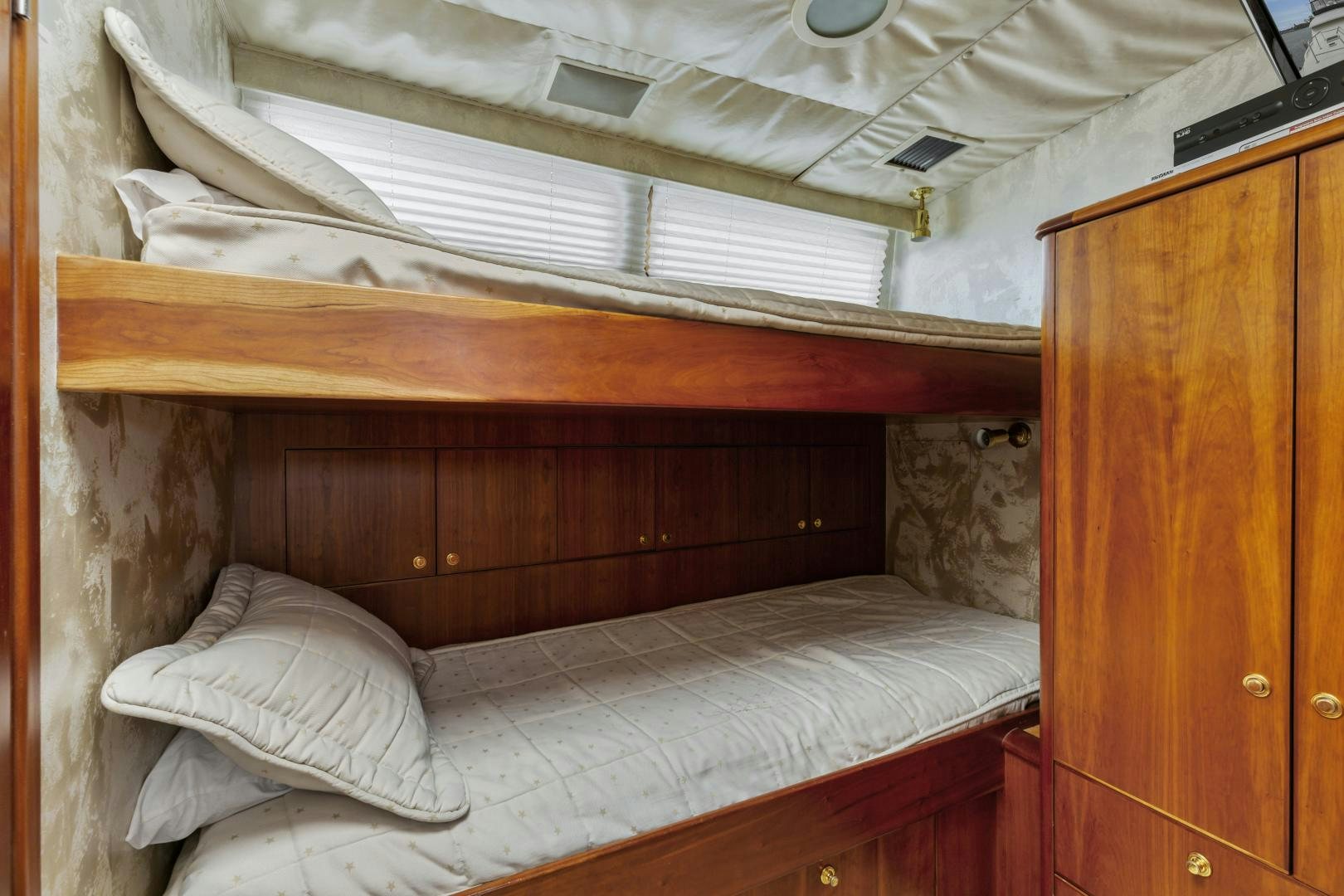 a bed with a white sheet aboard WANDERLUST Yacht for Sale