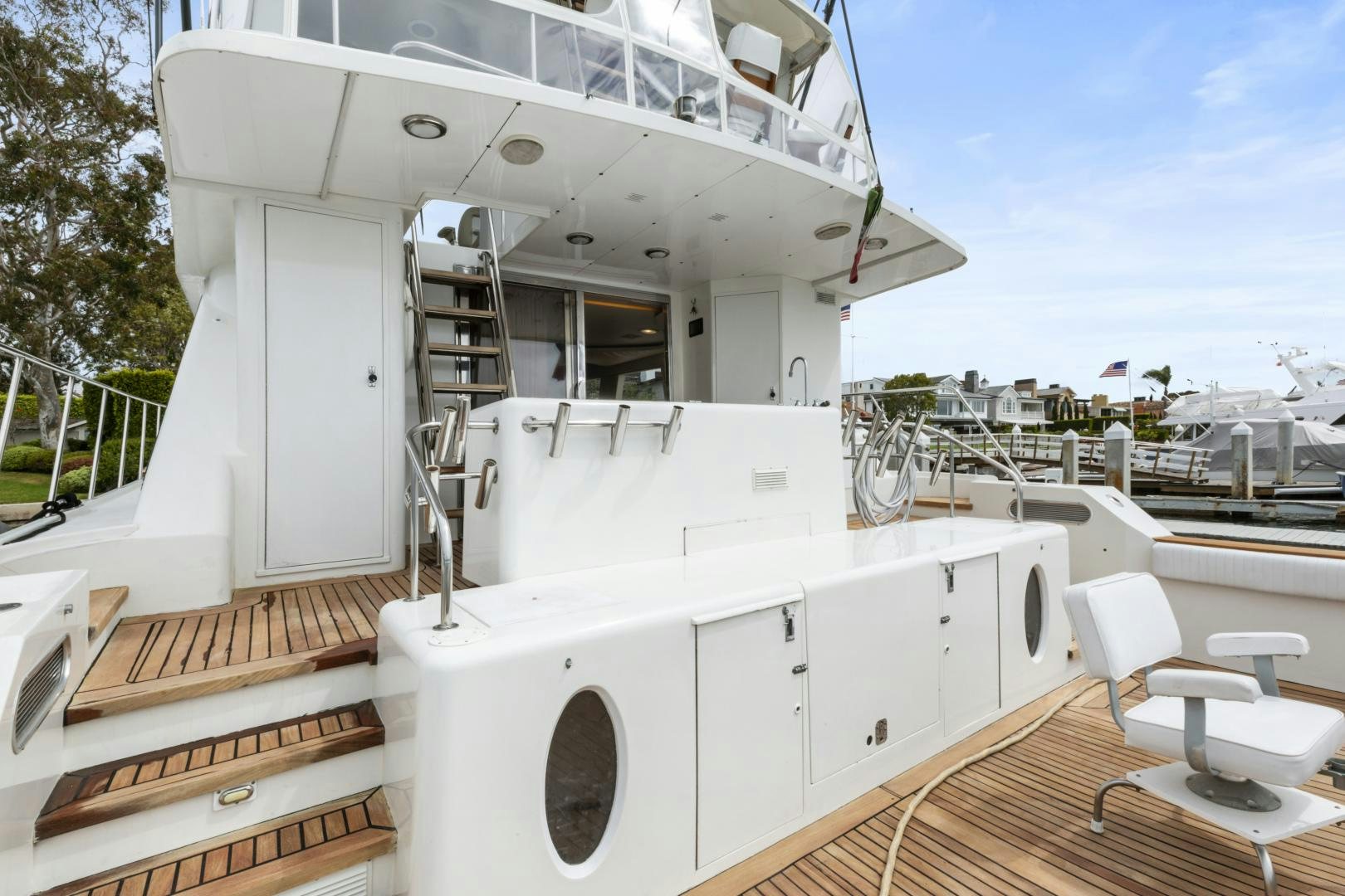 a large white boat with a white deck and chairs on a sunny day aboard WANDERLUST Yacht for Sale