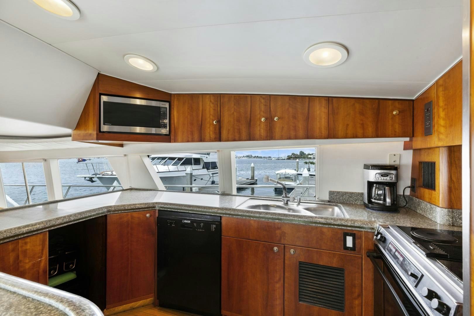 a kitchen with wooden cabinets aboard WANDERLUST Yacht for Sale