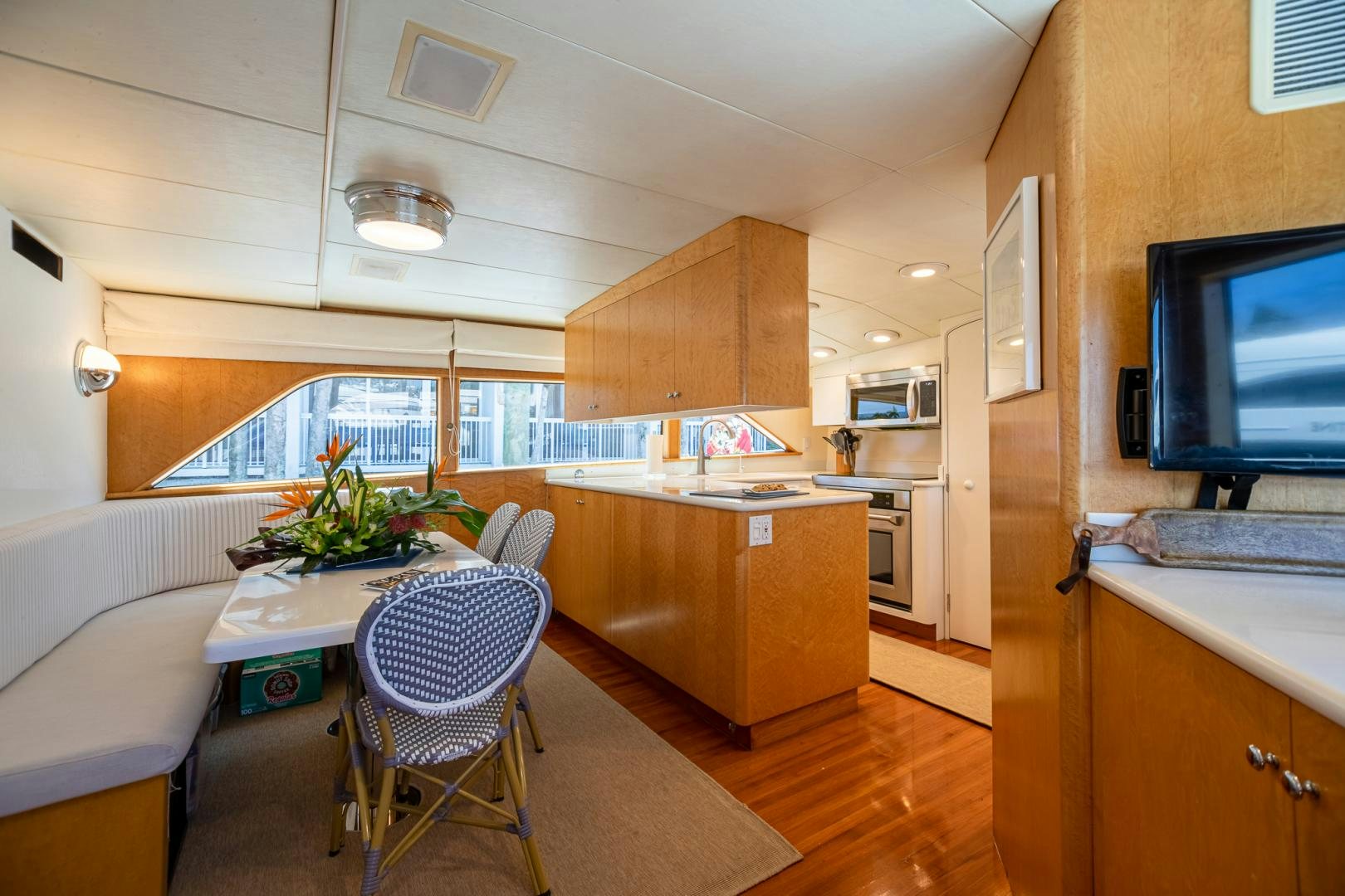 a kitchen with a tv and a table aboard SIRENE Yacht for Sale