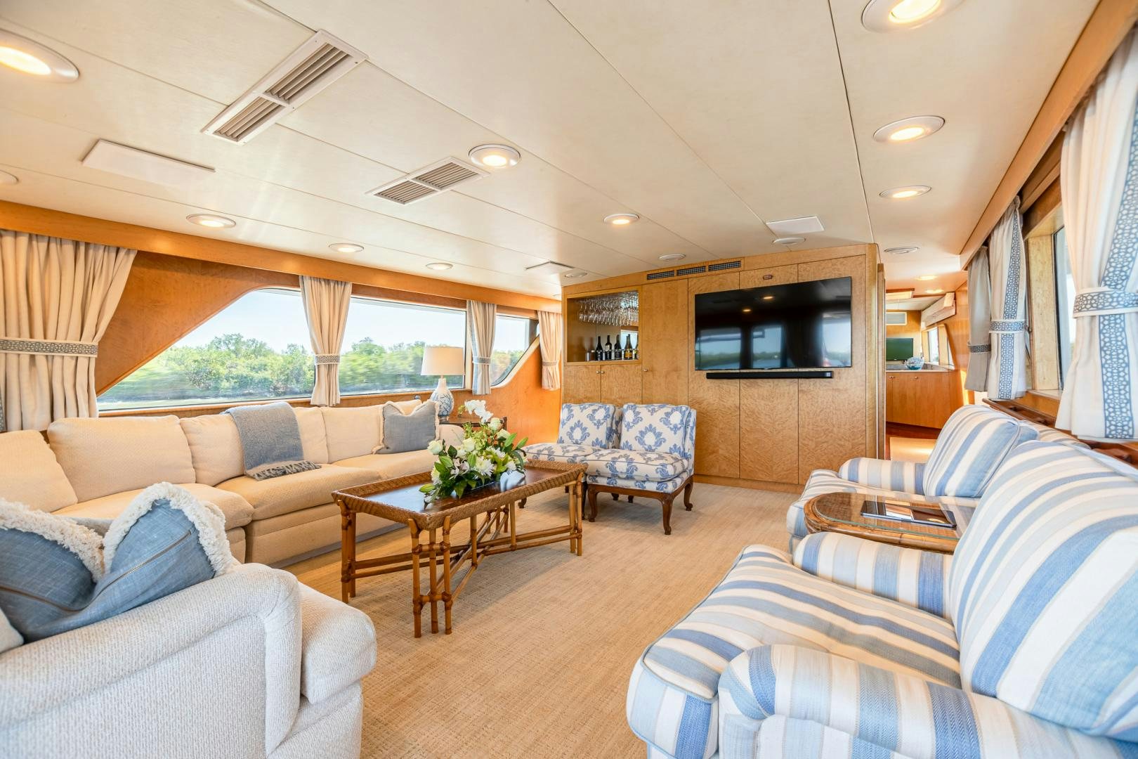 a living room with a couch and a television aboard SIRENE Yacht for Sale