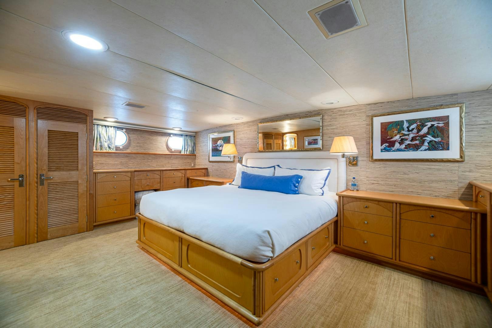 a bedroom with a bed and a desk aboard SIRENE Yacht for Sale
