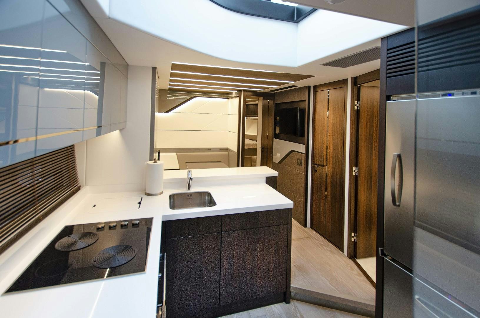 a kitchen with a sink and a refrigerator aboard DOUBLE OR NOTHING Yacht for Sale