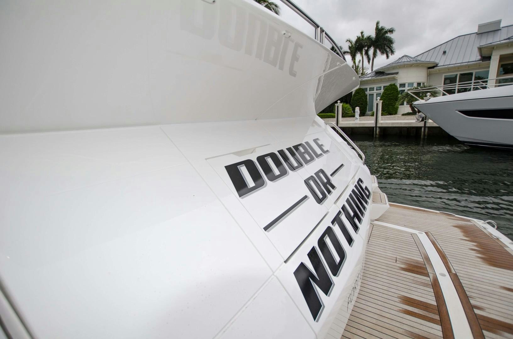 a white boat with a black and white logo on it aboard DOUBLE OR NOTHING Yacht for Sale