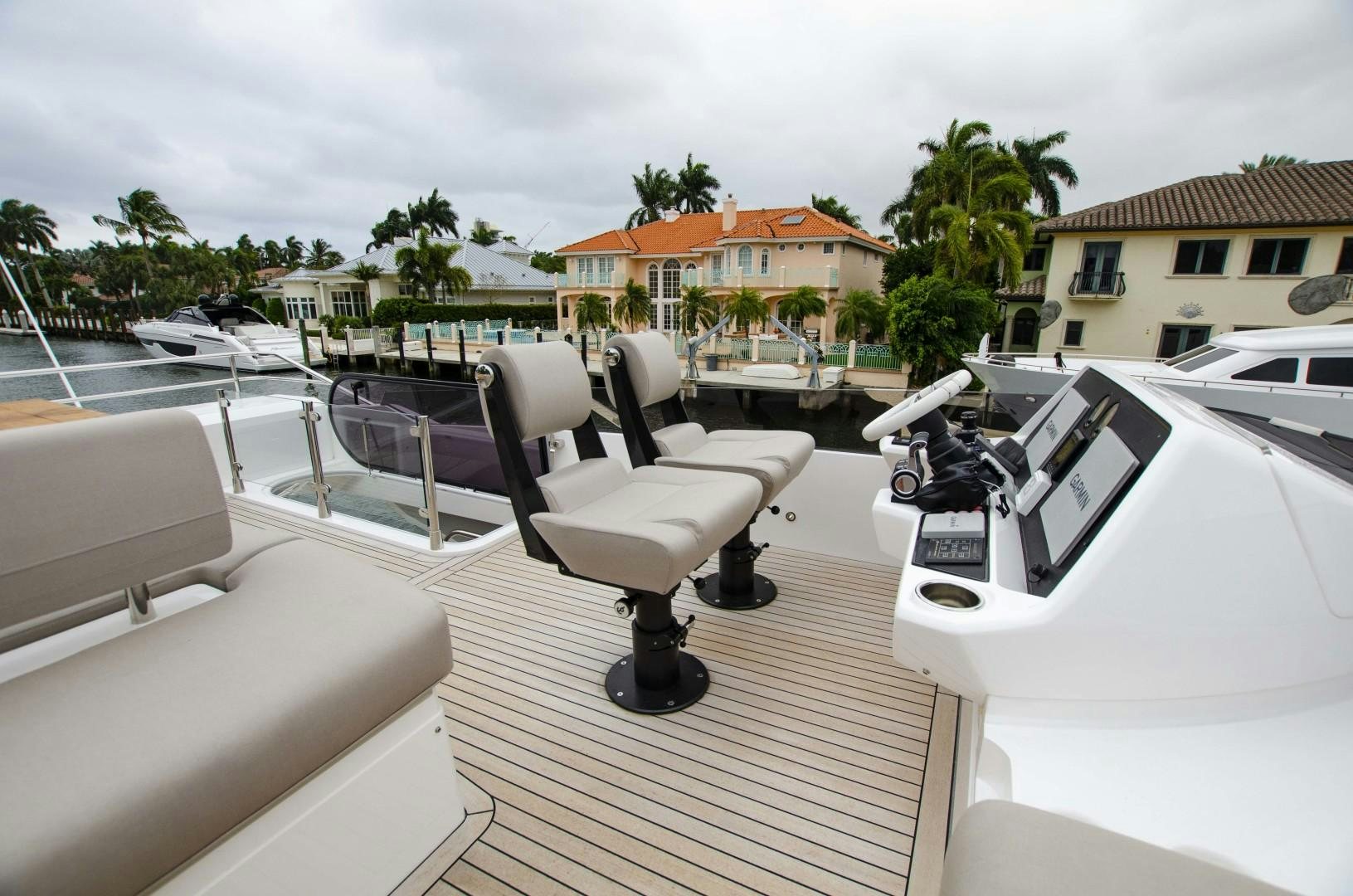 a deck with a deck chairs and trees and buildings aboard DOUBLE OR NOTHING Yacht for Sale