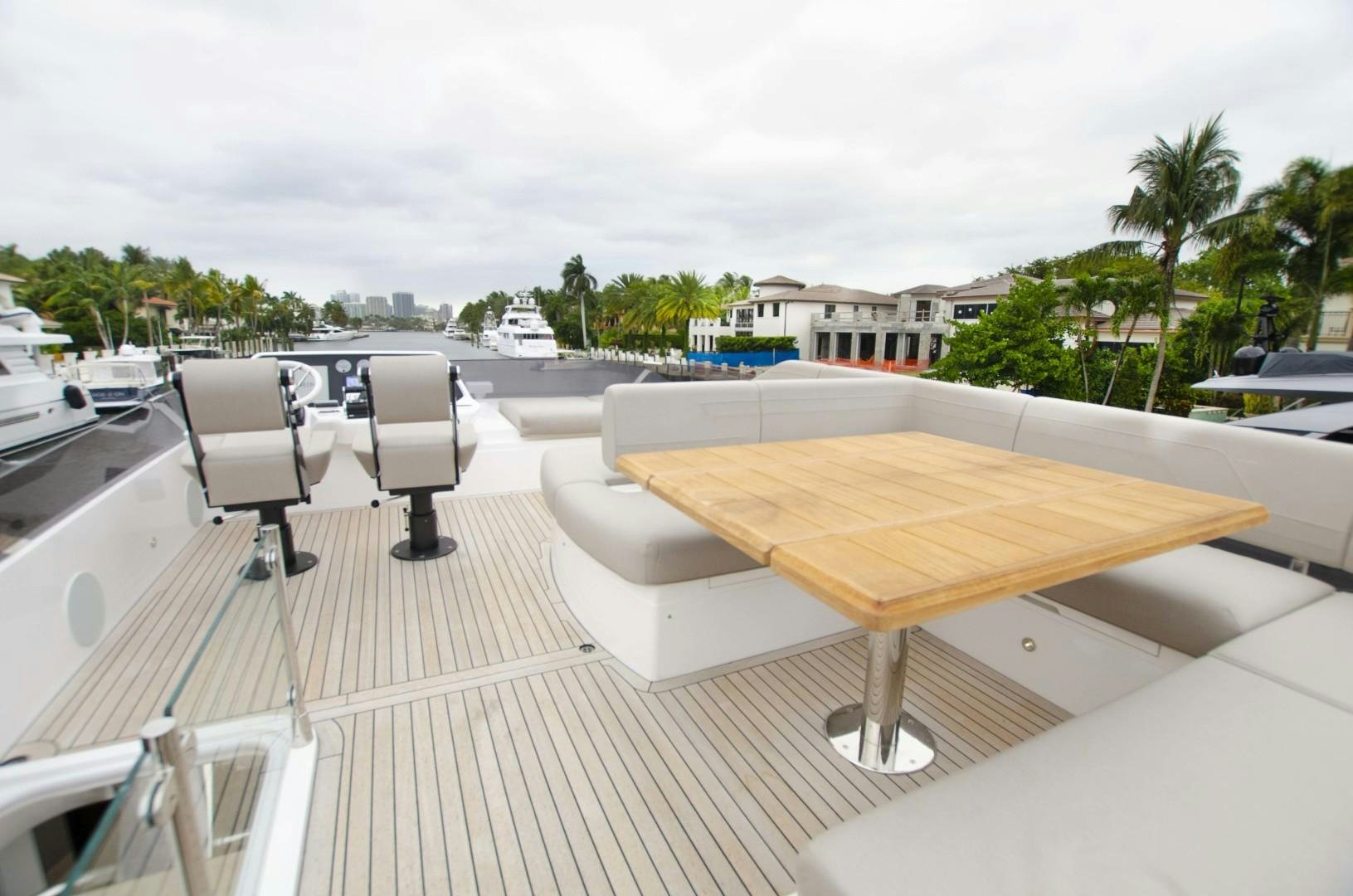 a deck with chairs and tables on it aboard DOUBLE OR NOTHING Yacht for Sale