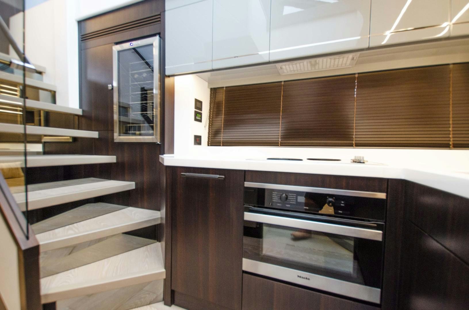a kitchen with wooden cabinets aboard DOUBLE OR NOTHING Yacht for Sale