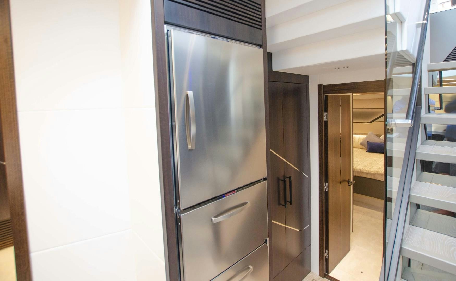 a kitchen with a stainless steel refrigerator aboard DOUBLE OR NOTHING Yacht for Sale
