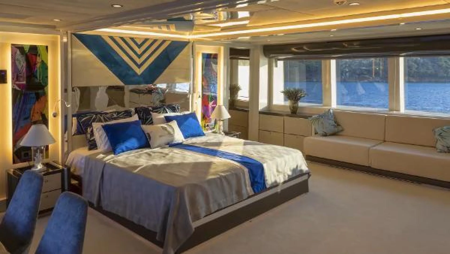 a room with a bed and a couch aboard VETRO Yacht for Sale