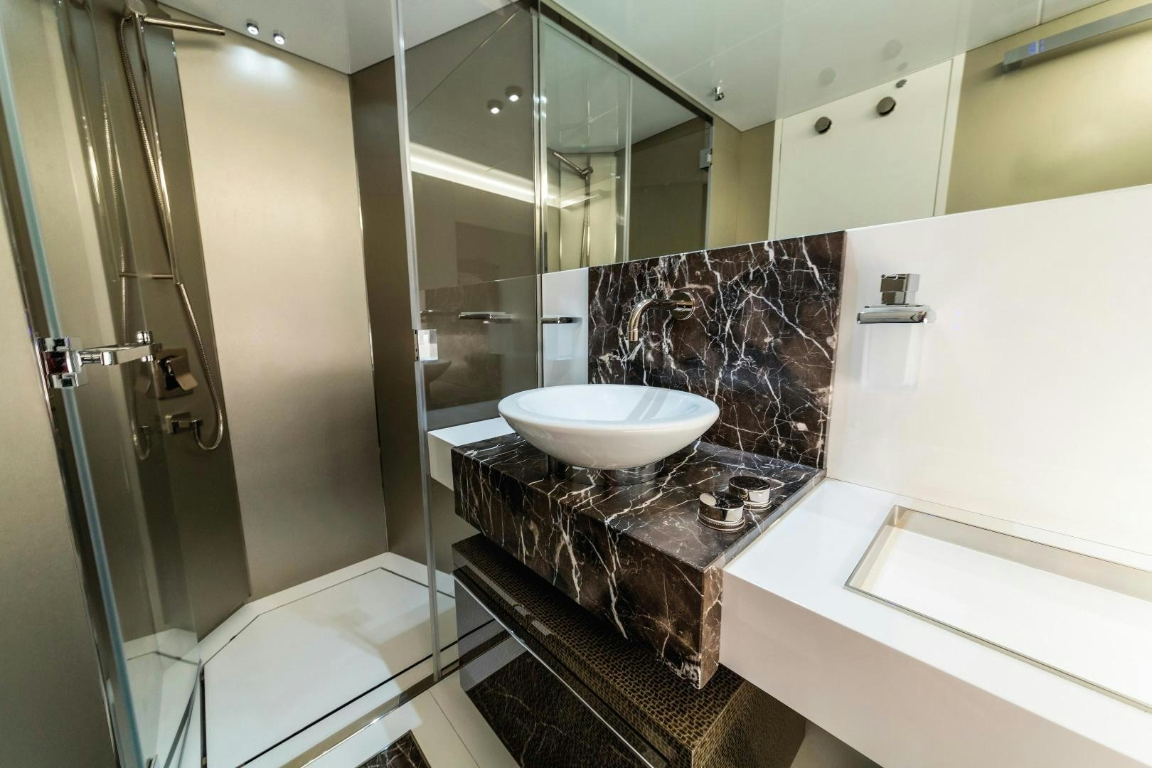 a bathroom with a sink and a shower aboard BOOMSHAKALAKA Yacht for Sale