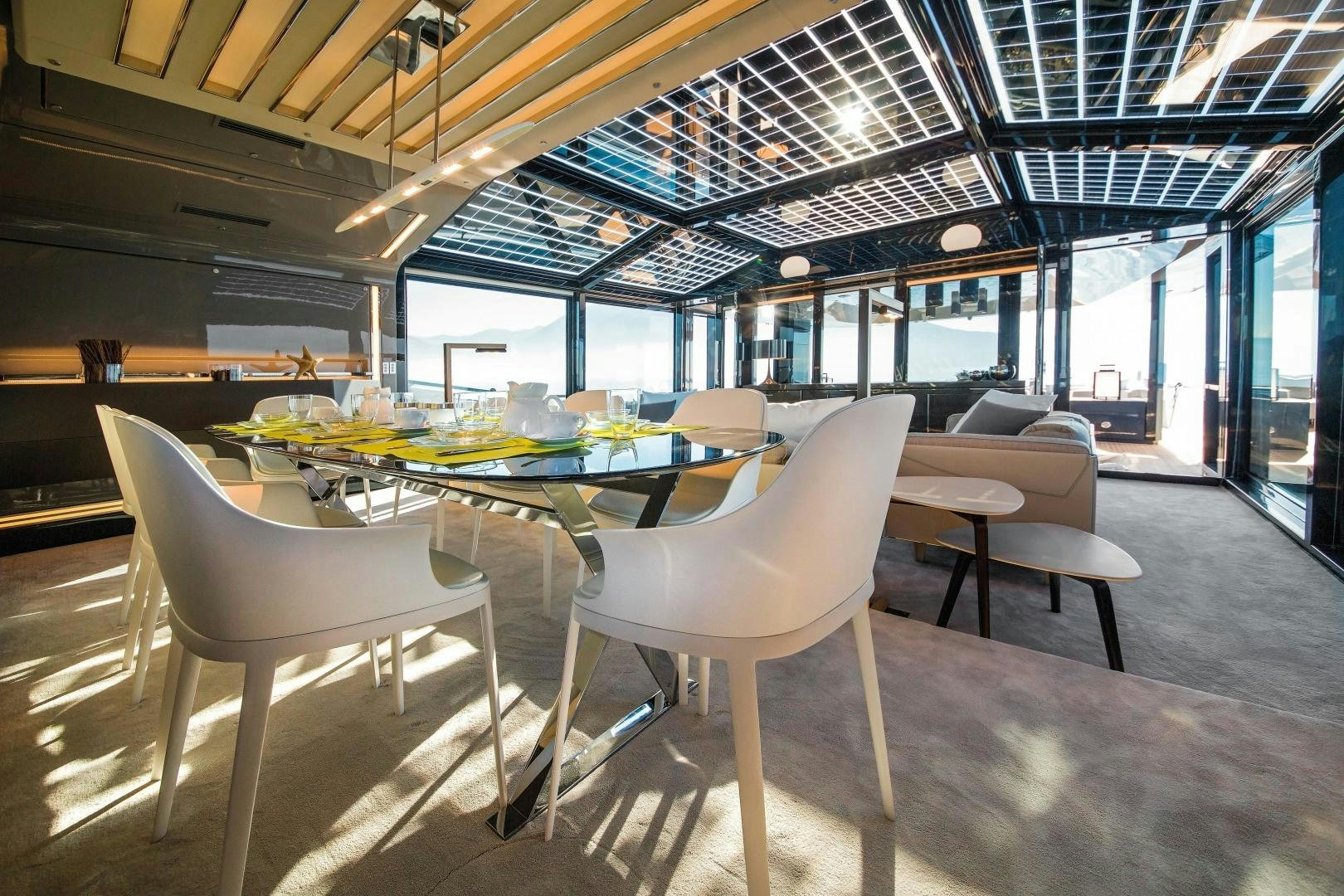 a room with tables and chairs aboard BOOMSHAKALAKA Yacht for Sale