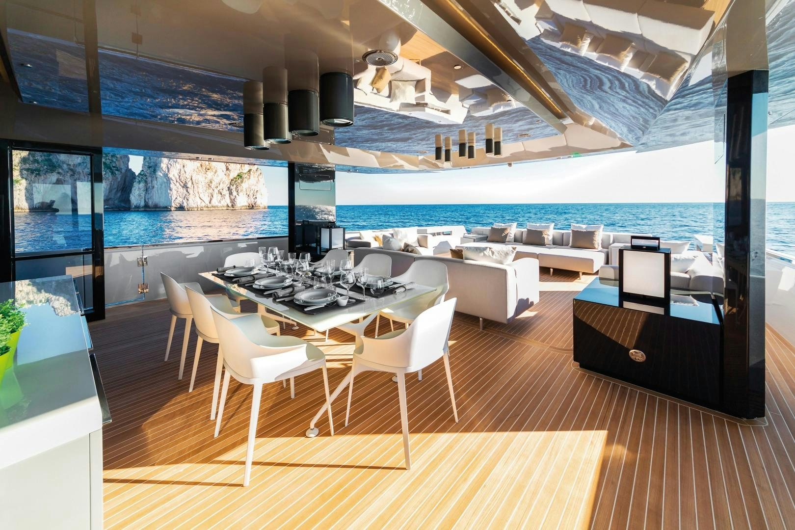 a room with a table chairs and a large window aboard BOOMSHAKALAKA Yacht for Sale