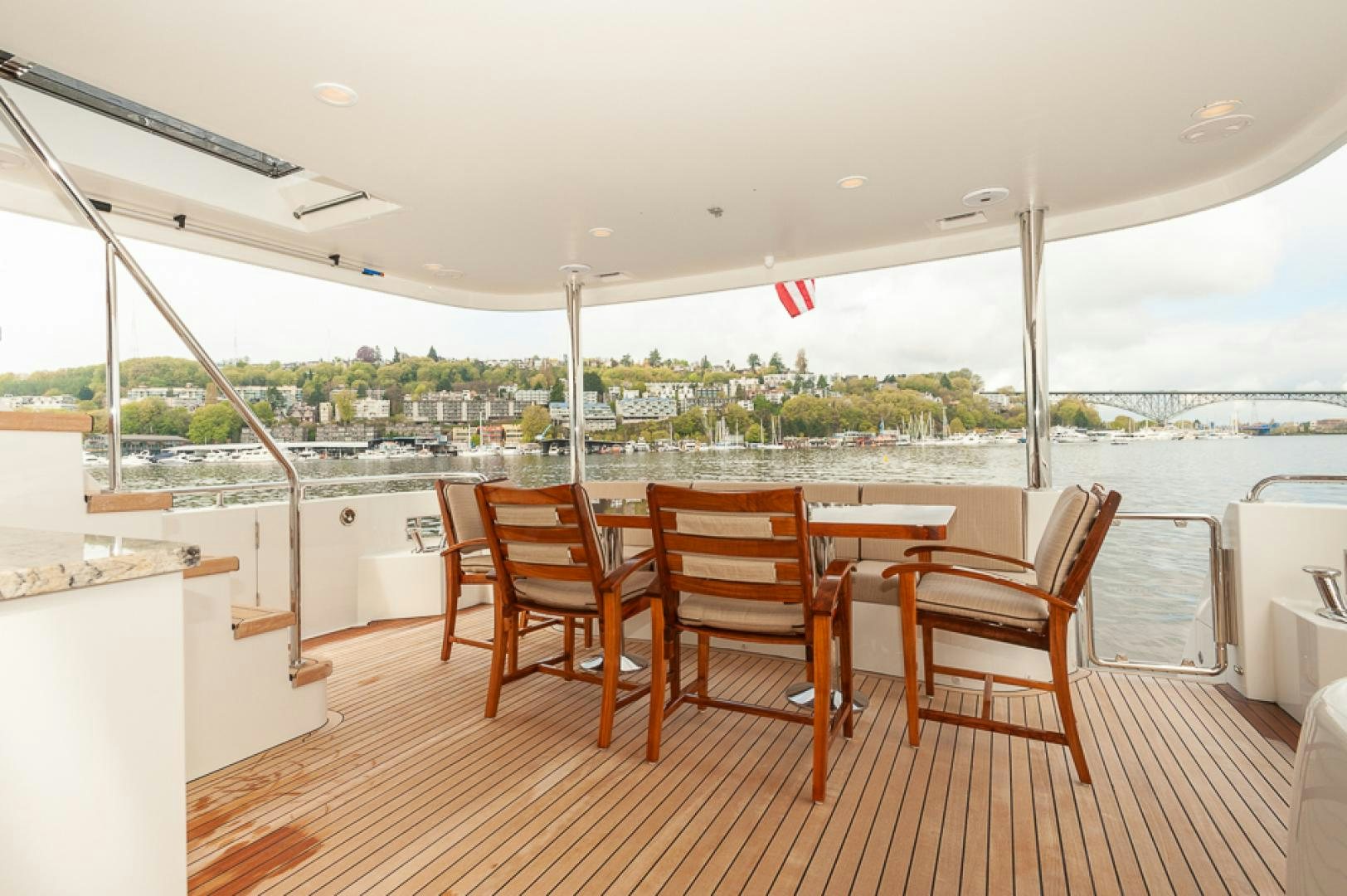a deck with chairs and tables aboard JEANNE SEA QUA Yacht for Sale