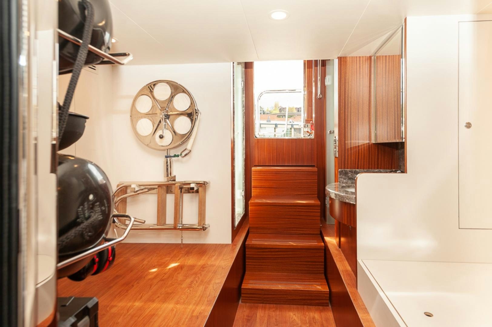 a room with a wood floor and a fan aboard JEANNE SEA QUA Yacht for Sale